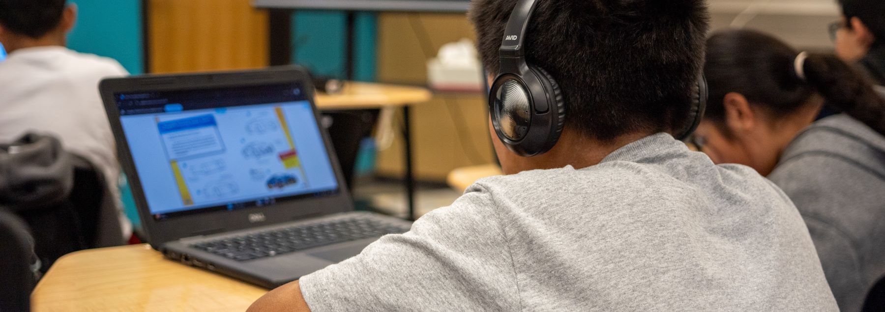 Student working on a laptop in class.